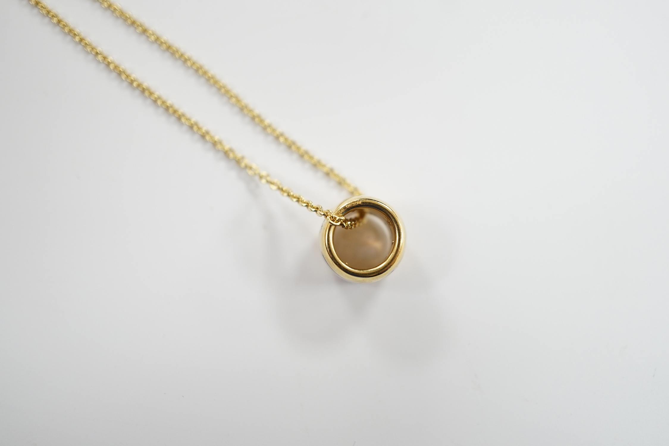 A modern Georg Jensen two colour 18ct gold barrel pendant, 10mm, on a Georg Jensen 18ct gold fine link chain, 42cm, gross weight 10.3 grams.